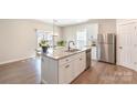 Modern kitchen with a large island, stainless steel appliances, and open layout to the dining area at 1124 Culver Spring Way, Charlotte, NC 28215