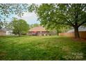 Spacious backyard with well-maintained lawn, patio area, and mature trees, perfect for outdoor living at 115 Stumpy Creek Rd, Mooresville, NC 28117