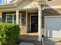 Inviting front porch with stone accents and black front door at 1177 Ellis Pond Dr, Rock Hill, SC 29730