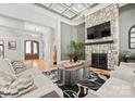 Inviting living room with stone fireplace, hardwood floors, and coffered ceilings at 129 Hunts Landing Dr, Mooresville, NC 28117