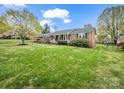 Brick ranch home with lush green lawn, mature landscaping, and charming front porch, great location at 1309 Briarcliff Rd, Shelby, NC 28152