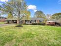 Charming brick ranch home with a well-manicured lawn, covered parking, and a cozy front porch at 1309 Briarcliff Rd, Shelby, NC 28152