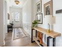 Bright entryway with natural light, hardwood floors, console table, and decorative art at 16004 Tulloch Rd, Charlotte, NC 28278