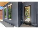 Stylish home entrance with modern door and window showcasing the contemporary exterior at 2008 St John St, Charlotte, NC 28216