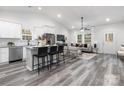 Open-concept living room with hardwood floors, bright white walls, and modern furnishings at 203 Park Ave, Mount Holly, NC 28120