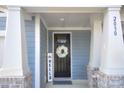 Inviting front entrance features a stylish wreath on the door and brick detailing at 2030 Bosna Ln, Fort Mill, SC 29715