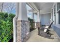 Inviting front porch offers rocking chairs, brick columns, and relaxing outdoor space at 2030 Bosna Ln, Fort Mill, SC 29715