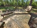 Large wooden deck with built-in seating, perfect for outdoor relaxation and entertaining at 2213 Wheaton Way, Monroe, NC 28112