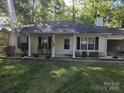 Charming single-story home with rocking chairs on the front porch and well-maintained landscaping at 2213 Wheaton Way, Monroe, NC 28112