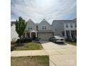 Traditional two-story home boasts a two-car garage, covered porch, and a well-manicured lawn at 3042 Burnello Ct, Iron Station, NC 28080