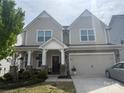 Charming two-story home features a covered porch, two-car garage, and well-maintained landscaping at 3042 Burnello Ct, Iron Station, NC 28080