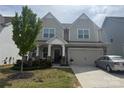 Charming two-story home features a covered porch, two-car garage, and well-maintained landscaping at 3042 Burnello Ct, Iron Station, NC 28080
