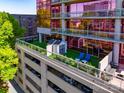 View of a rooftop patio in a modern condo building with parking garage and patio furniture at 315 Arlington Ave # 506 & 507, Charlotte, NC 28203