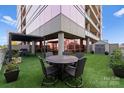 Charming condo rooftop patio with outdoor seating and lush artificial turf, ideal for relaxing and enjoying outdoor gatherings at 315 Arlington Ave # 506 & 507, Charlotte, NC 28203