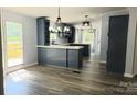 Bright eat-in kitchen with modern lighting, gray cabinets, white countertops and stainless steel sink at 3325 Stony Brook Cir, Newton, NC 28658