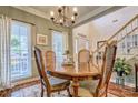 Elegant dining area featuring a round wood table with comfortable seating and natural light from nearby windows at 394 Runnymede Dr, Rock Hill, SC 29732