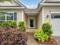 Charming front entrance with colorful landscaping leading to a glass front door at 527 Livingston Dr, Lancaster, SC 29720