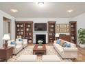 Cozy living room featuring a fireplace, hardwood floors, bookshelves, and comfortable seating at 527 Livingston Dr, Lancaster, SC 29720