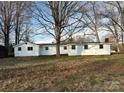 Rear exterior of a white home with a dark roof and bare trees surrounding the property at 539 Jennings Rd, Statesville, NC 28625