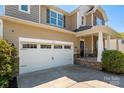 Close-up of a two-car garage with a white door and a well-maintained driveway at 6061 Piscataway Ct, Rock Hill, SC 29732
