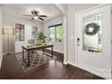 Bright home office with a ceiling fan, built-in cabinets, and large windows overlooking the front yard at 6061 Piscataway Ct, Rock Hill, SC 29732