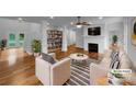 Bright living room with a fireplace, wood floors, and built-in shelving at 6204 River Birch Dr, Gastonia, NC 28056