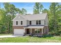 Inviting two-story home featuring brick and siding, a well-kept lawn, and an attached garage at 8937 Penstemons Dr, Charlotte, NC 28215