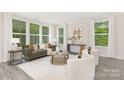 Bright and airy living room with large windows, neutral décor, and stylish modern furniture at 8937 Penstemons Dr, Charlotte, NC 28215