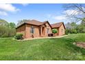 Charming brick home with manicured lawn, complemented by mature trees and inviting front entrance at 121 Capstone Ct, Statesville, NC 28625