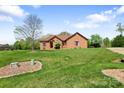 All brick home situated on a green lawn with a beautiful blue sky backdrop, offering curb appeal at 121 Capstone Ct, Statesville, NC 28625