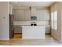 Open kitchen with gray cabinets, white subway tile backsplash, stainless steel appliances, and large island at 1216 Morehead Dr, Salisbury, NC 28144
