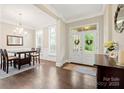 Elegant foyer with hardwood floors, chandelier, and double doors leading outside at 13044 Fen Ct, Huntersville, NC 28078