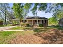 Inviting brick home with a classic covered porch and carport at 1337 Eastside Ave, Albemarle, NC 28001