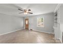 Neutral living room featuring wood paneling and tiled flooring at 1337 Eastside Ave, Albemarle, NC 28001