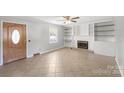 Bright living room with tiled floor, built in shelves, and a fireplace at 1337 Eastside Ave, Albemarle, NC 28001