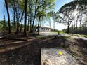 Exterior shot of the home nestled among mature trees, providing a sense of privacy and seclusion at 1407 Clarksville Campground Rd, Monroe, NC 28112