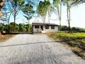 Front exterior view of a home with fresh gravel drive leading up to the house at 1407 Clarksville Campground Rd, Monroe, NC 28112