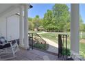 Inviting front porch with a view of the meticulously landscaped front yard, driveway, and surrounding greenery at 16610 Blackberry Hills Dr, Midland, NC 28107