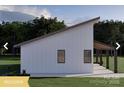 Side view of a modern farmhouse featuring clean lines, a covered patio, and well-maintained landscaping at 180 Nc 742 Hwy, Wadesboro, NC 28170