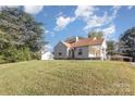 A charming single-story home with a front porch and a well-maintained lawn surrounded by trees at 2001 S Main St, Kannapolis, NC 28081