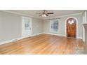 Bright living room with hardwood floors, vintage door and window, and a ceiling fan at 2001 S Main St, Kannapolis, NC 28081
