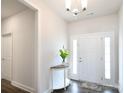 Inviting entryway with half-round table, pendant lighting, and sidelights at 221 Mountain Island Dr, Statesville, NC 28677