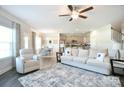 Open-concept living room with kitchen and dining areas, features lots of natural light and stylish furnishings at 221 Mountain Island Dr, Statesville, NC 28677