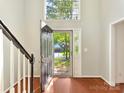 Grand entryway with high ceilings, hardwood floors, and a view of the home's exterior through the front door at 2805 Bathgate Ln, Matthews, NC 28105