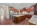 Open kitchen with a large island, stainless steel appliances and lots of wooden cabinetry at 3060 Drummond Ave, Indian Land, SC 29707