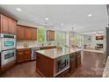 Modern kitchen features an island, stainless steel appliances, and seamless transition to living area at 3060 Drummond Ave, Indian Land, SC 29707