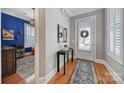 Entryway with hardwood floors, neutral walls, decorative table and rug leading to a brightly lit office space at 374 Horton Grove Rd, Fort Mill, SC 29715