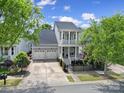 Beautiful two-story home featuring a three car garage, second story balcony and landscaped front yard at 374 Horton Grove Rd, Fort Mill, SC 29715