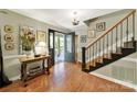 Bright foyer with hardwood floors, staircase, chandelier, and an inviting front door with glass at 4 Hummingbird Ct, Clover, SC 29710