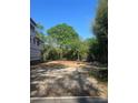 The property lot features partial construction and tree coverage under a clear, blue sky at 4105 Walker Rd, Charlotte, NC 28211